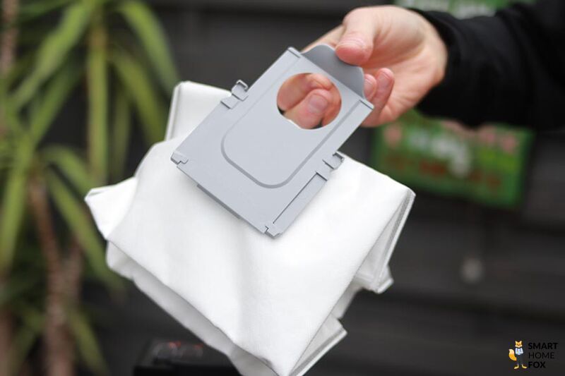 Disposable dust bag is removed from the Roborock Q7 Max+ suction station.